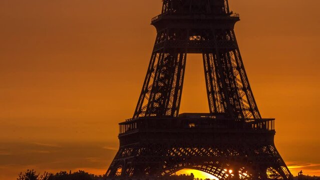 Eiffel Tower sunrise timelapse close up view with orange sky in Paris, France. View from Grenelle bridge early morning