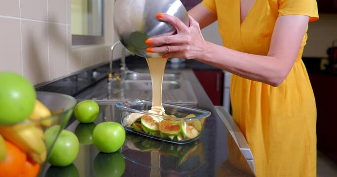 Woman cooking an apple pie in her kitchen