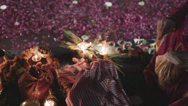 holy offerings for hindu sun god at river side at chhath festival by indian devotee at night