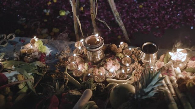 traditional holy offerings of burning oil lamp at river side at chhath festival by devotee