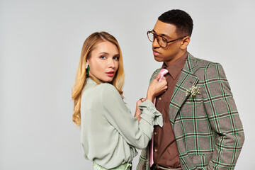 A man and woman showcasing affectionate, striking poses for camera.