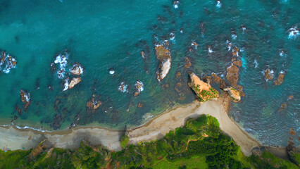 Top view of coast with rocks in water and forest. Clip. Amazing nature of coast with beautiful...