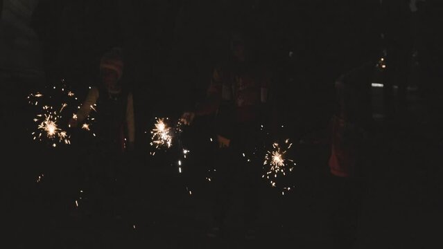 kids enjoying Pencil crackers or indian Phuljhadi fireworks holding in hand at Diwali celebration