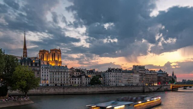 Notre Dame de Paris with Le Pont D'Arcole bridge after sunset day to night transition timelapse, Paris, France, Europe. People and boats. Colorful sky at summer day with reflection on river Seine