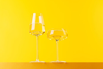 Champagne elegance: Glasses with sparkling wine against a vibrant yellow background