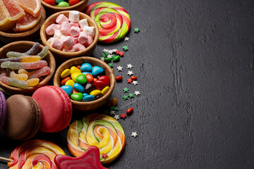Various colorful candies, lollipops, and macaroons