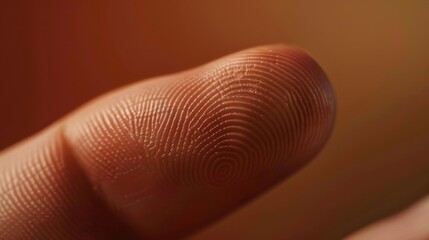 Finger with friction ridges on dark background, macro view