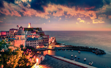 Illuminated morning cityscape of Vernazza port. Dramatic summer sunrise on Liguria, Cinque Terre,...