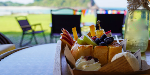 toast and ice cream on a picnic basket on the table in the garden