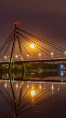 Obraz premium Full Moon rising on background bridge in Kyiv, Ukraine