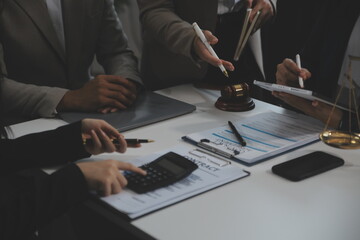 Judge gavel with Justice lawyers having team meeting at law firm background. Concepts of Law and Legal services.