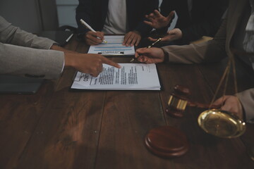 Judge gavel with Justice lawyers having team meeting at law firm background. Concepts of Law and...