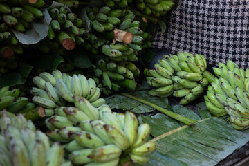 selective focus lots of green bananas in the truck Always buy fresh bananas from villagers.