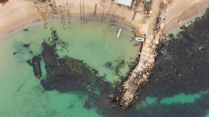 Aerial view of a sunken boat. Sunken ship at shallow depth, near the beach