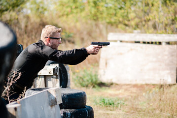 A man with a pistol in her hand undergoes military training at a training ground and learns to...