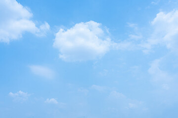 Blue Sky and Fluffy Clouds in Bright Summer Day