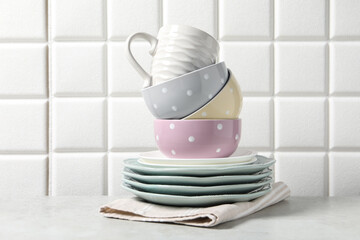 Beautiful ceramic dishware and cup on light grey table