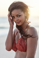 Woman, portrait and calm on beach, nature and bikini on ocean shore for confidence on weekend trip. Female person, peace and breeze by sea on vacation, swimsuit and outdoor travel to tropical island