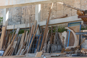 wooden planks and other elements of a construction site supported on concrete pillars
