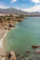 view of the seashore and the mountains of the village of Nerja in Malaga, Spain.