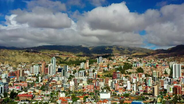 Aerial Panning Beautiful View Of Residential Buildings In City By Tranquil Mountains On Sunny Day - La Paz, Bolivia