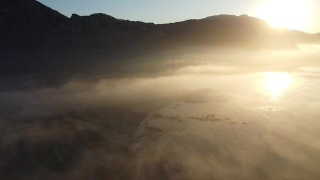 Pringle Bay Western Cape - breathtaking beauty of a sunrise over a foggy bay with majestic mountains in the distance. 