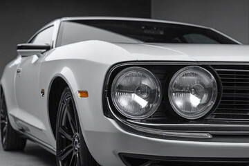 front half side of the sedan, showing the bumper, headlight, and windshield