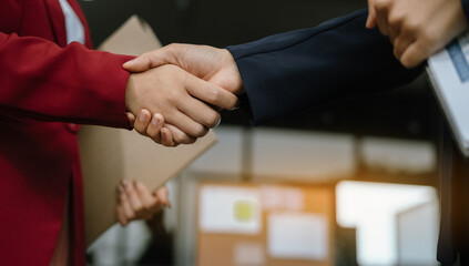 businesswoman shaking hands at group board meeting.
