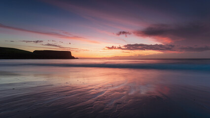 Fototapeta premium Beautiful landscape of sunset over lake sea, clouds blend of yellow, pink, and blue