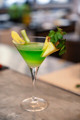 Vibrant Green Cocktail with Pineapple Garnish


