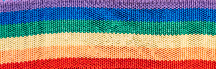 Background closeup of knitted LGBT flag.