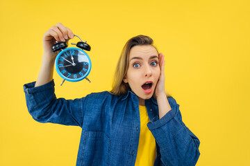 Hurry up! High time for deadline. Shocked impressed surprised caucasian young happy woman touching...