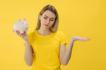 unhappy woman holding piggy bank in hands. show no money, bankruptcy, poorness. Caucasian person...