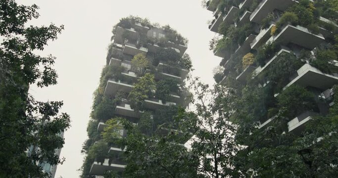 Green house Bosco Verticale in Milan Italy. Modern architecture of ecological multi-apartment buildings, urban landscape of a tourist city. High quality 4k footage