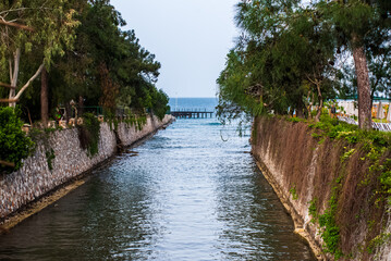 Fototapeta premium The river flows from the mountains and enters the Mediterranean Sea, not far from Kemer, Türkiye.