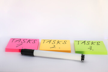 notes and markers with the writing of the tasks