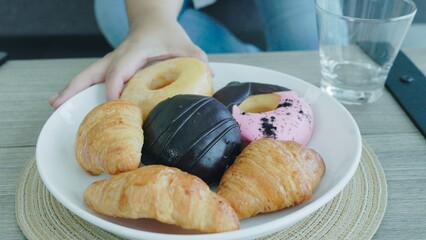 Closeup People eating donuts and bakery 