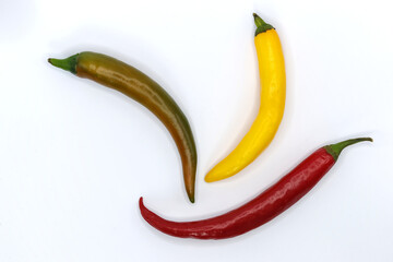 colorful chili peppers photographed on a white background