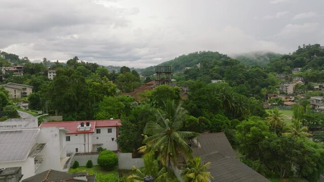 Aerial view of residential district of kandy, sri lanka, capturing the city's lush greenery, hilly landscape, and hourse from above