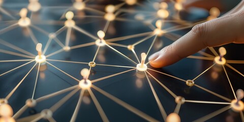 Close-up of a finger pressing a lit node on a network of connections, representing technology, communication, and interactivity