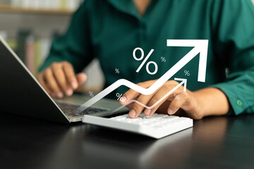 Interest rate concept, Business man using calculator with graph percentage symbol and up arrow,...