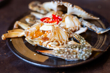 pickled fresh crab marinated in fish sauce on plate in a restaurant
