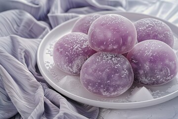 White plate filled with vibrant purple balls of food japanese sweet mochi rice cakes. Creating an appealing and colorful culinary presentation.