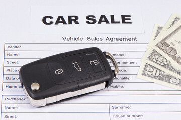 Car key, dollar banknotes and vehicle sales agreement. Sales or purchases new or used vehicle