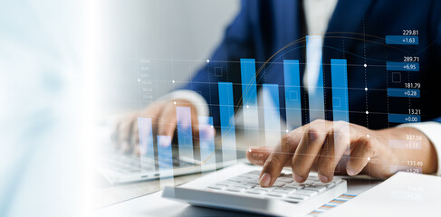 Businessman using calculator and laptop analyzing sales data economic growth graph chart strategic...