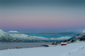 The magical light of the ending polar day on the snowy hills of Lofoten, Norway