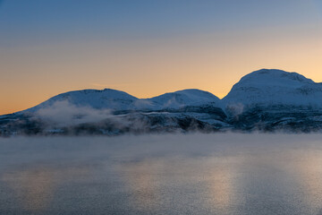 The magical light of the ending polar day on the snowy hills of Lofoten, Norway