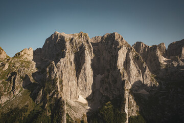 Rocky mountain tops with greenery and moss-covered cliffs