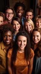 Fototapeta premium A group of smiling young adults from diverse backgrounds huddle together for a cheerful portrait