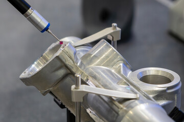 The  CMM probe measuring the  aluminum automotive parts.